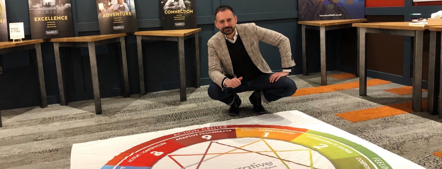 Hans Schumann, Enneagram coach in London, with a large Enneagram floor map at a workshop