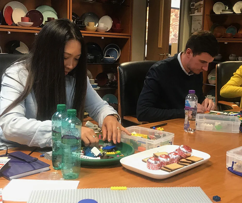 Participants building LEGO® models at a facilitated team event