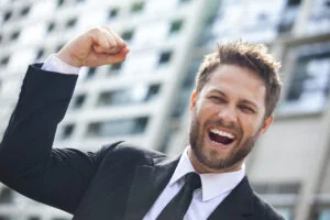 A businessman celebrating with his arm raised